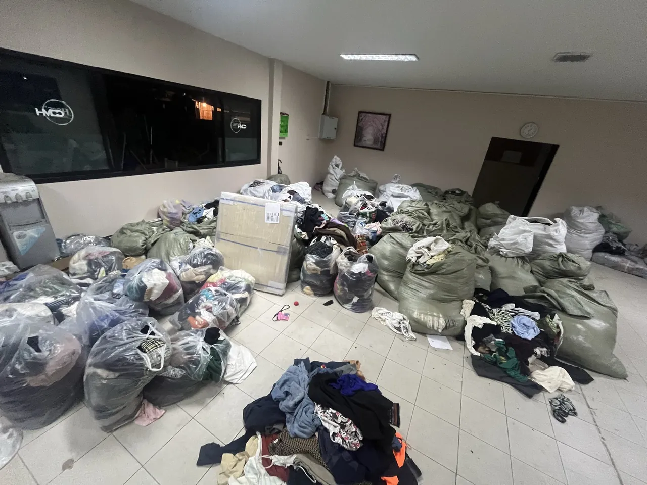 Bags of donated clothing gathered for humanitarian assistance.